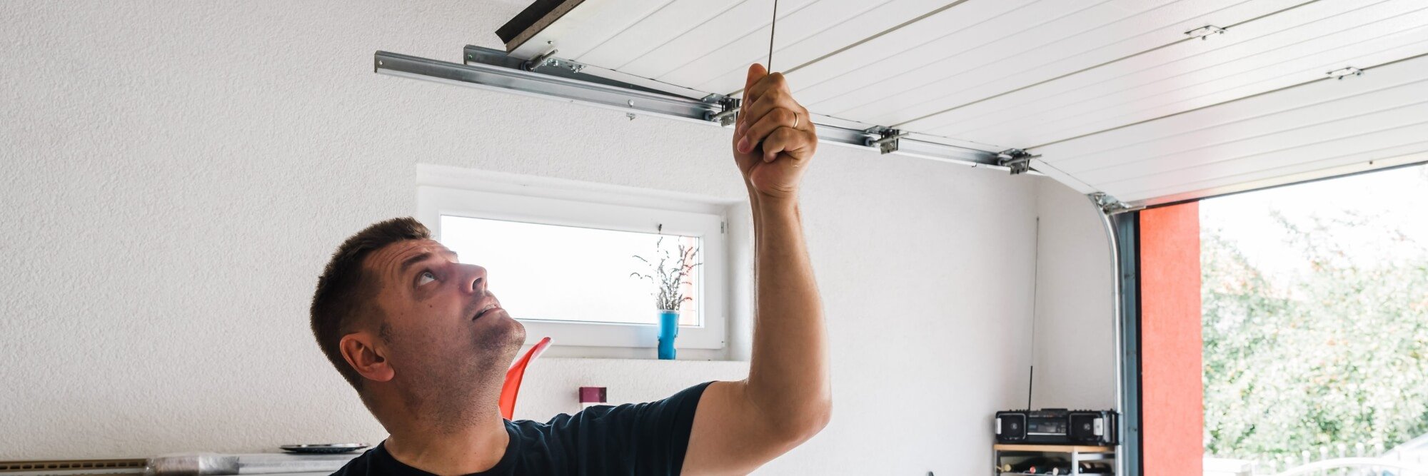 Garage door safety - A man uses the manual override system to open his garage door